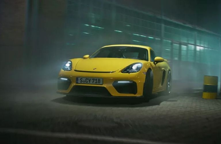 Exterior view of the front of a yellow 2020 Porsche 718 Cayman GT4