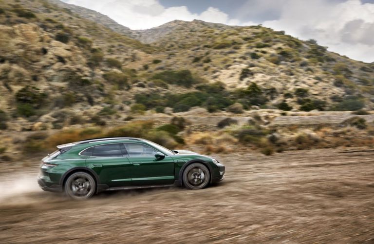 2025 Porsche Taycan driving on a tough trail