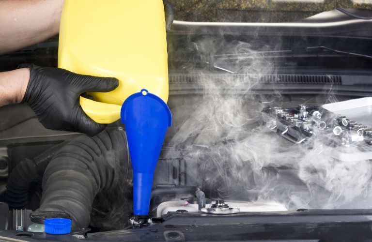 Mechanic pouring coolant